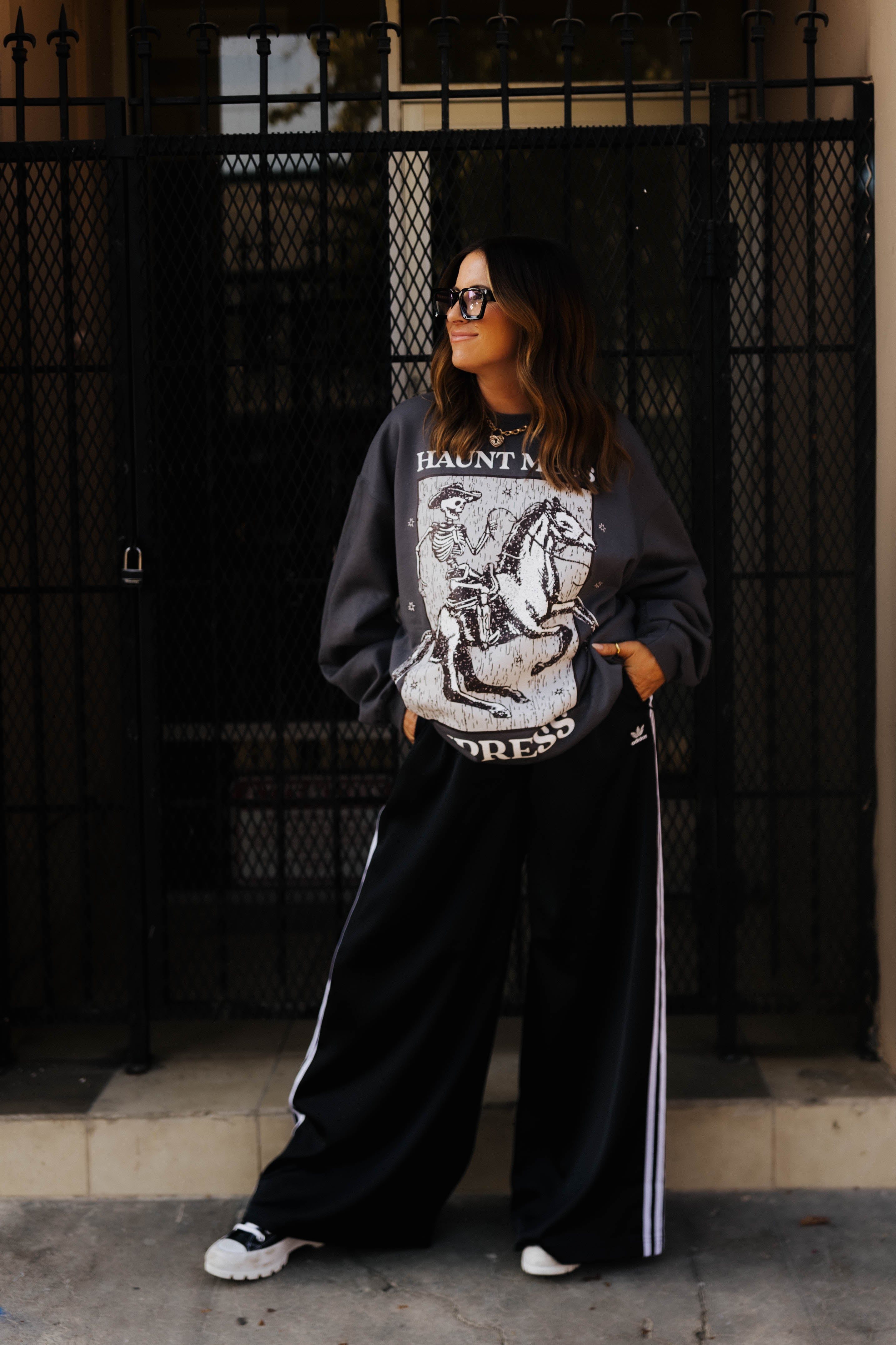 model krista wearing haunt mess express sweatshirt looking away