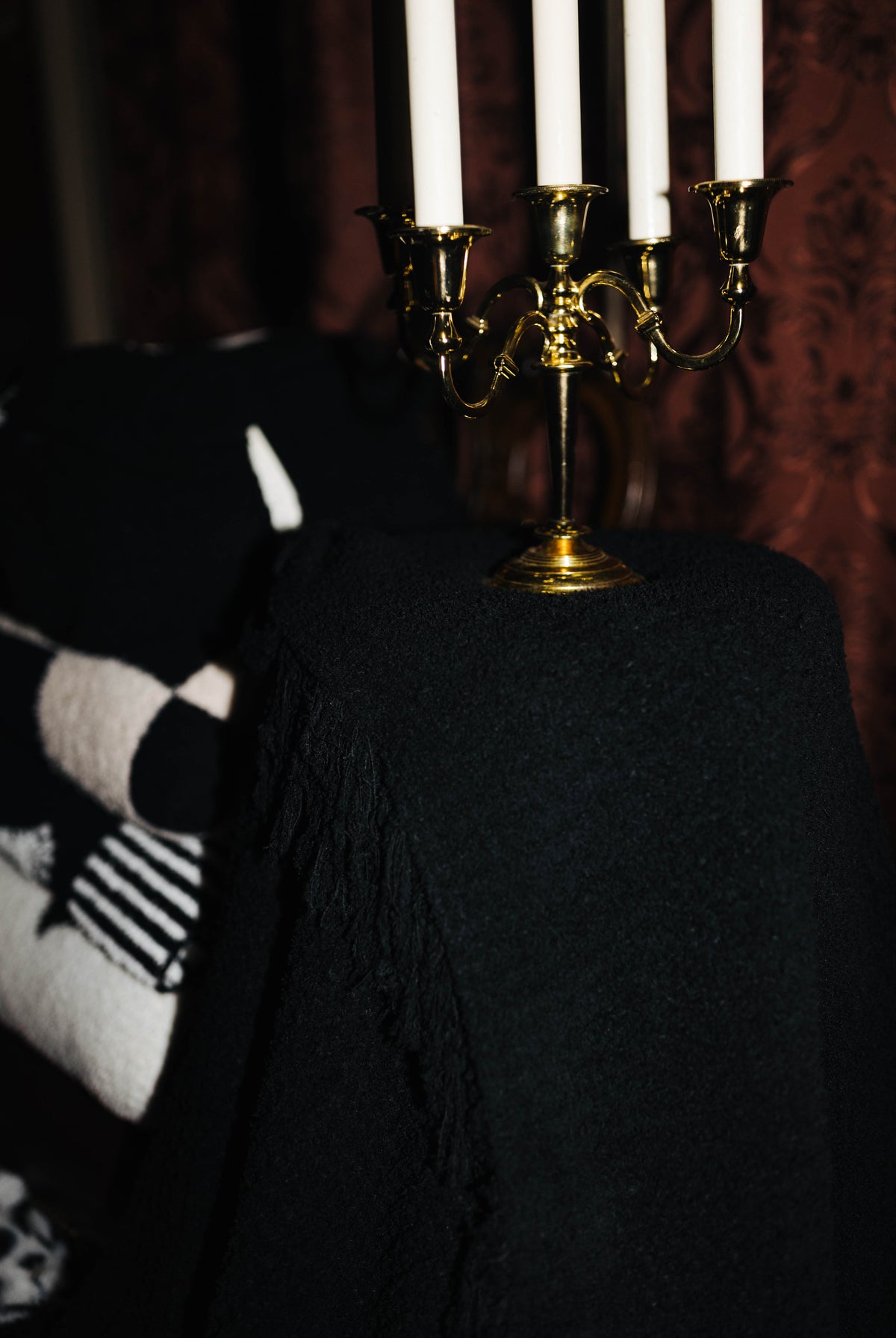 Black Waffle Fringe Blanket 90x90 shown in a full length lifestyle view