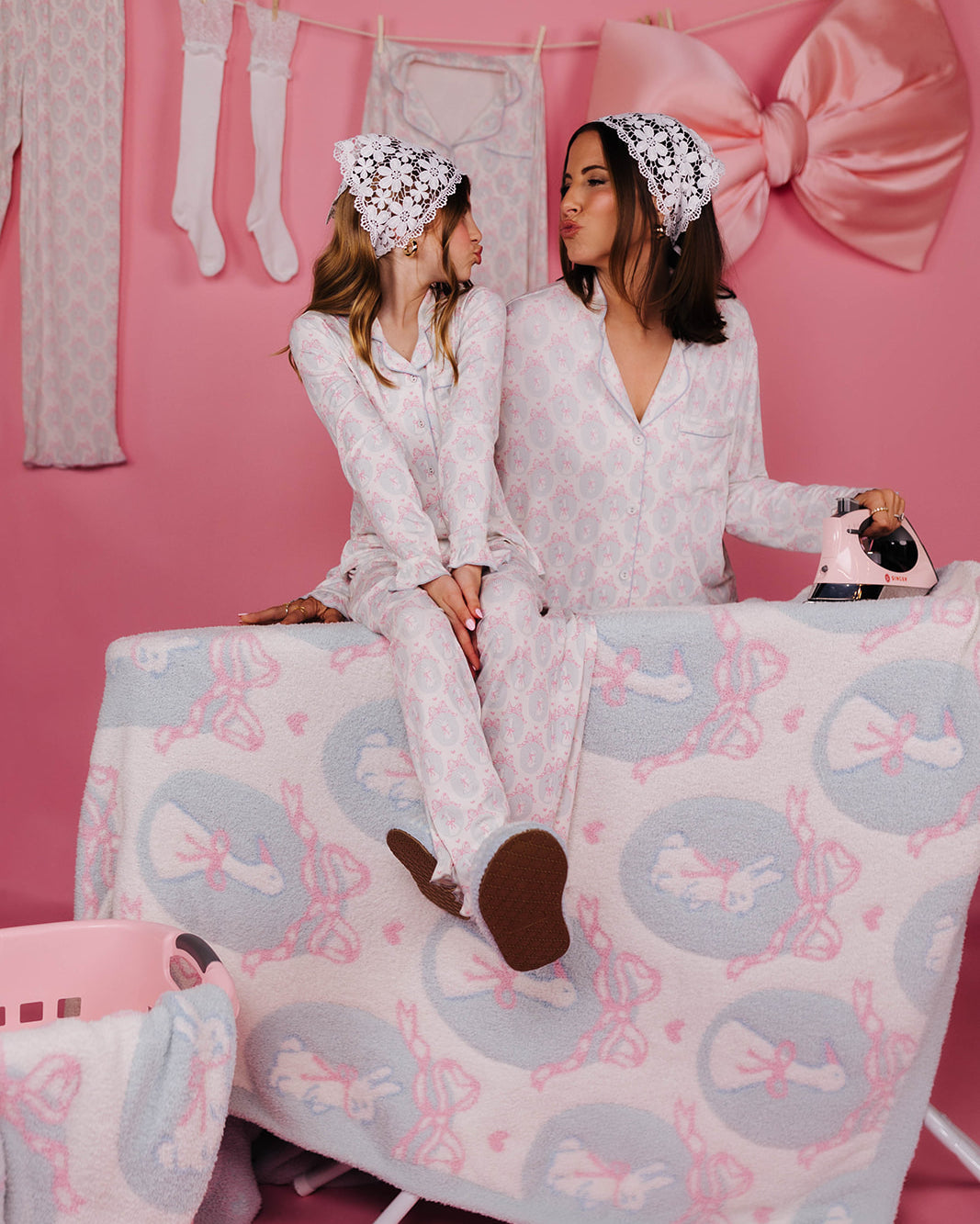 Kolly sitting on the ironing board looking at Krista while making kissy faces