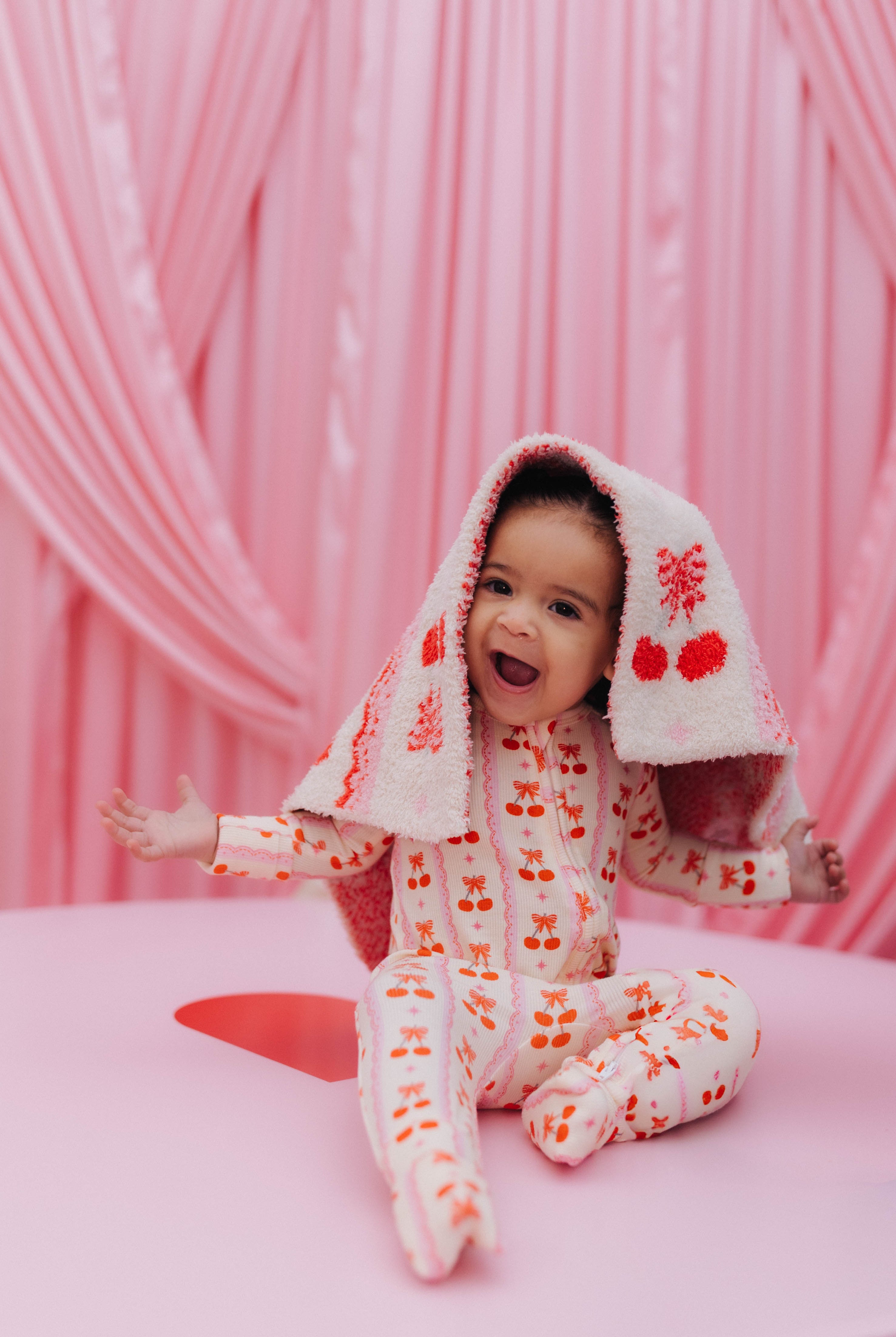 baby with the blanket on their head