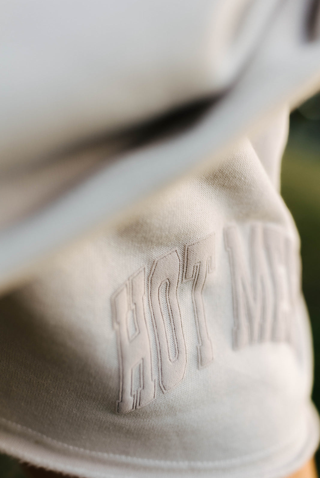 Close-up of shorts with hot mess puff print