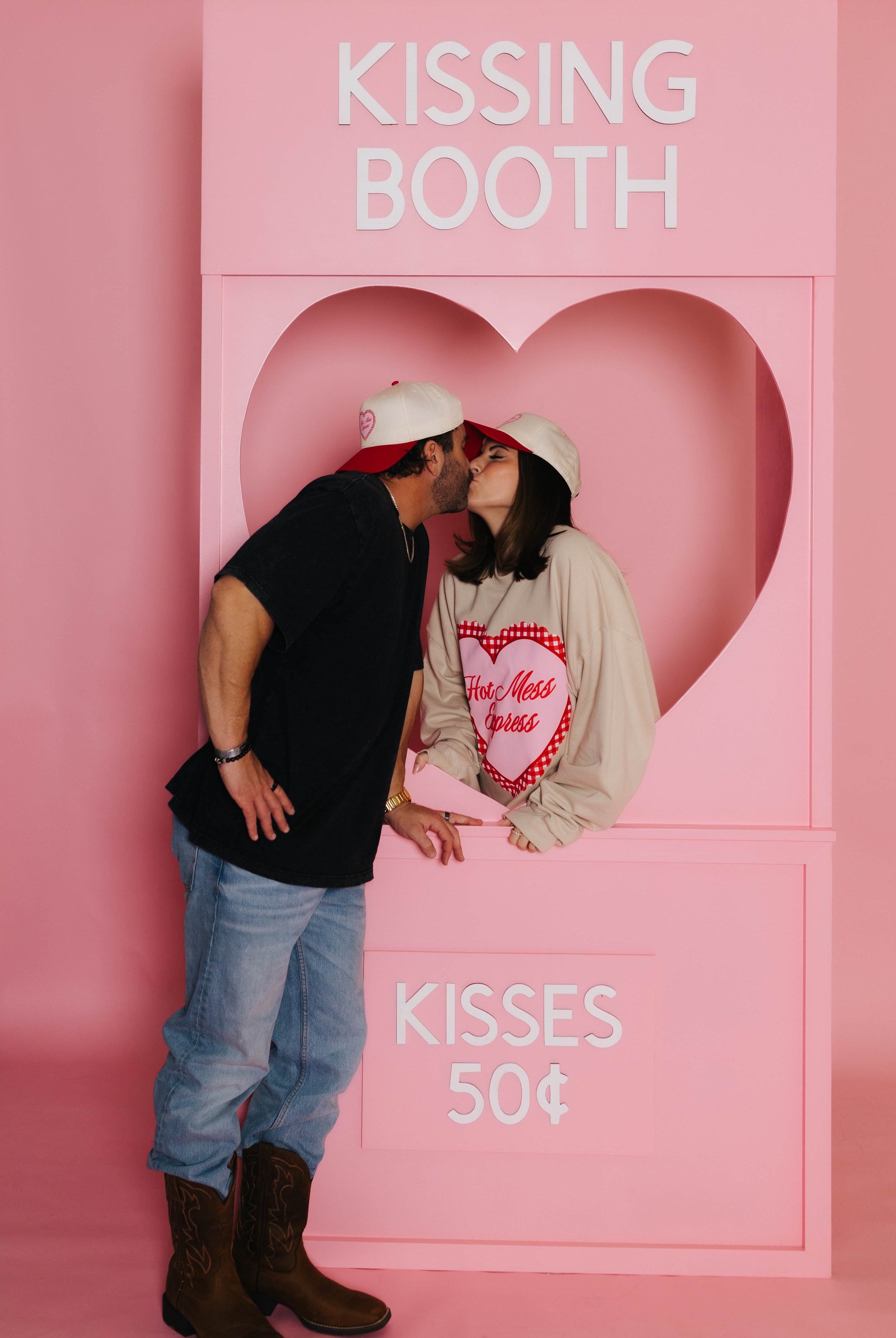 Bryce and Krista kissing in the kissing booth