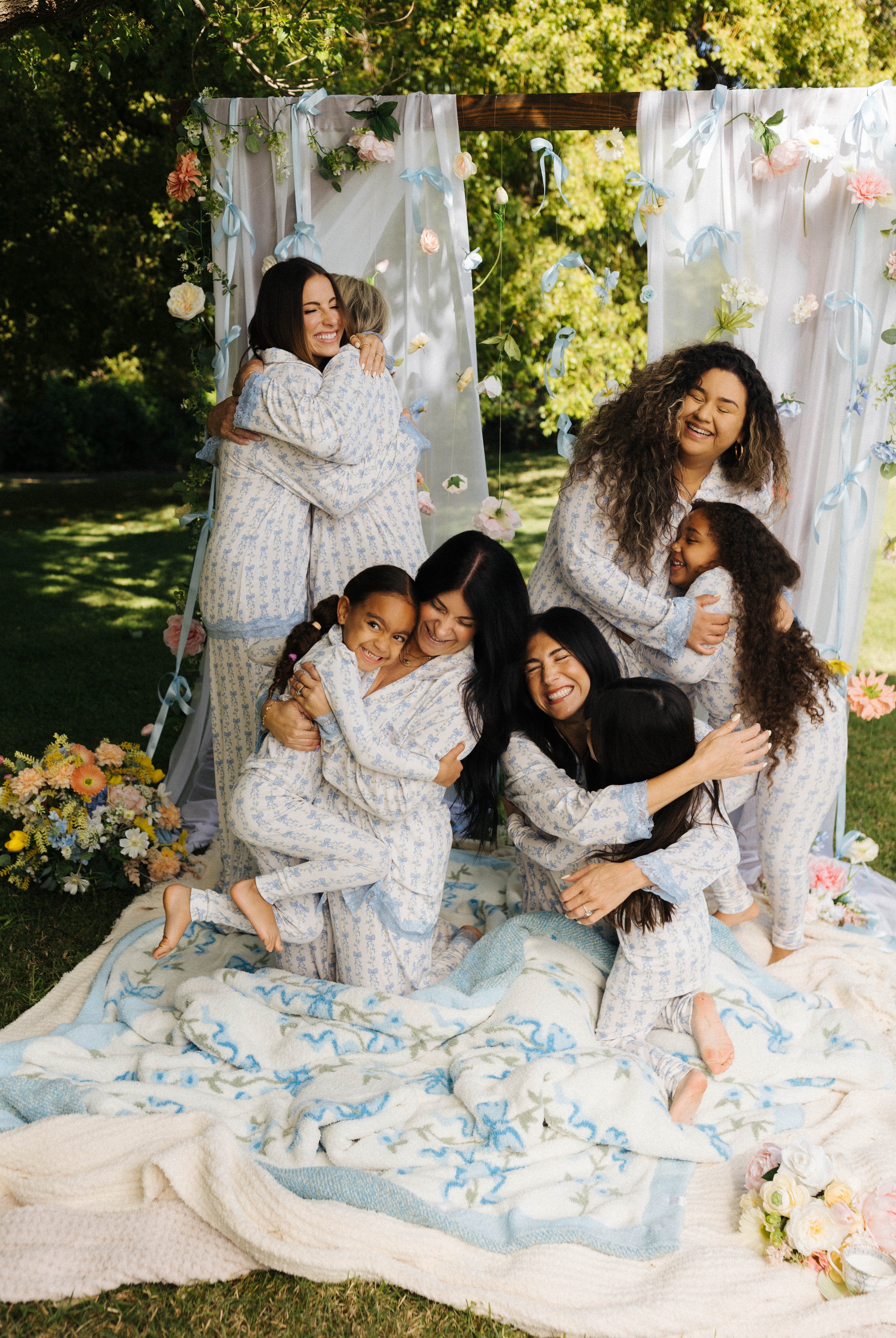 mom and their kids hugging in their matching pjs