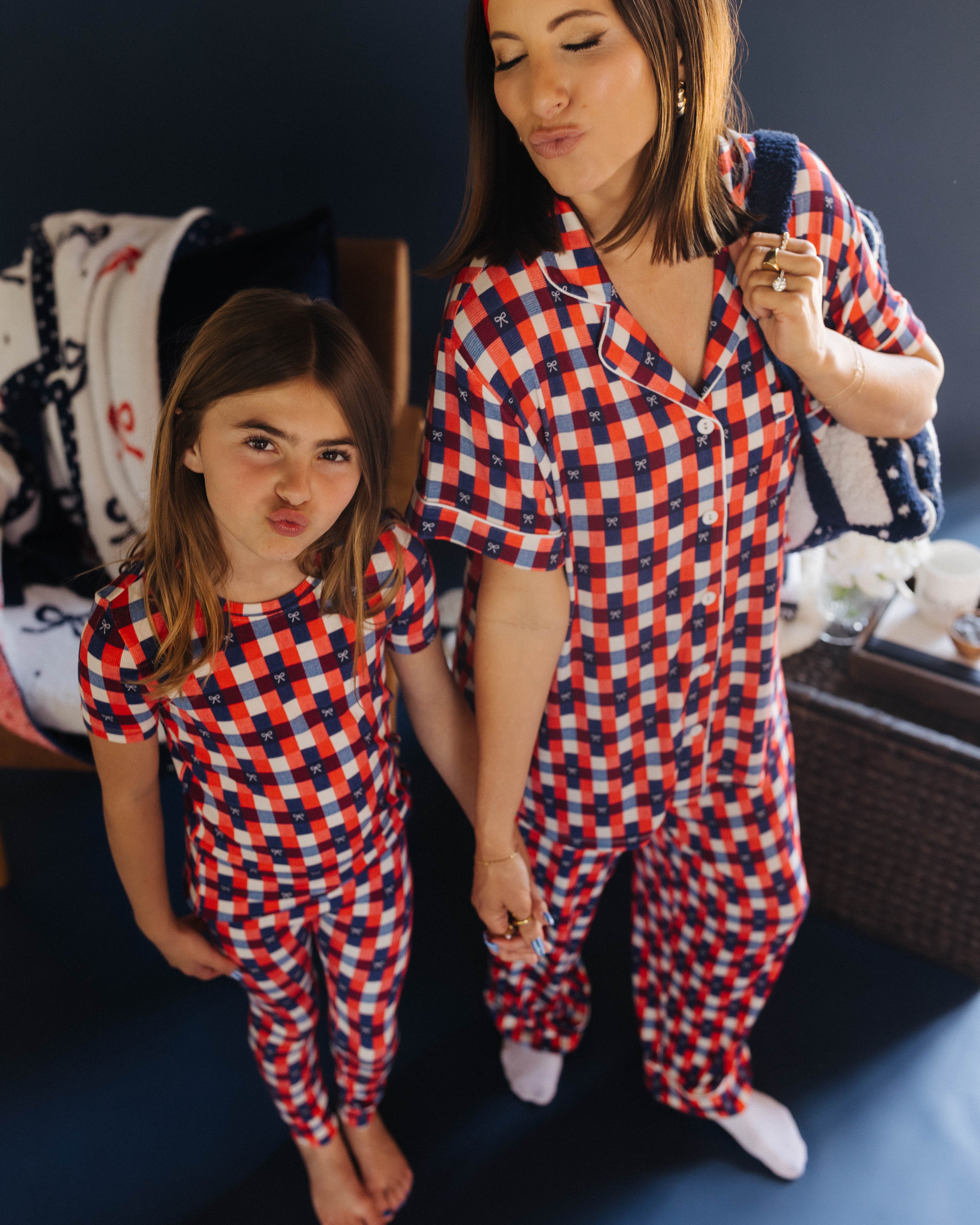 mom and daughter posing in matching pjs making kissy face