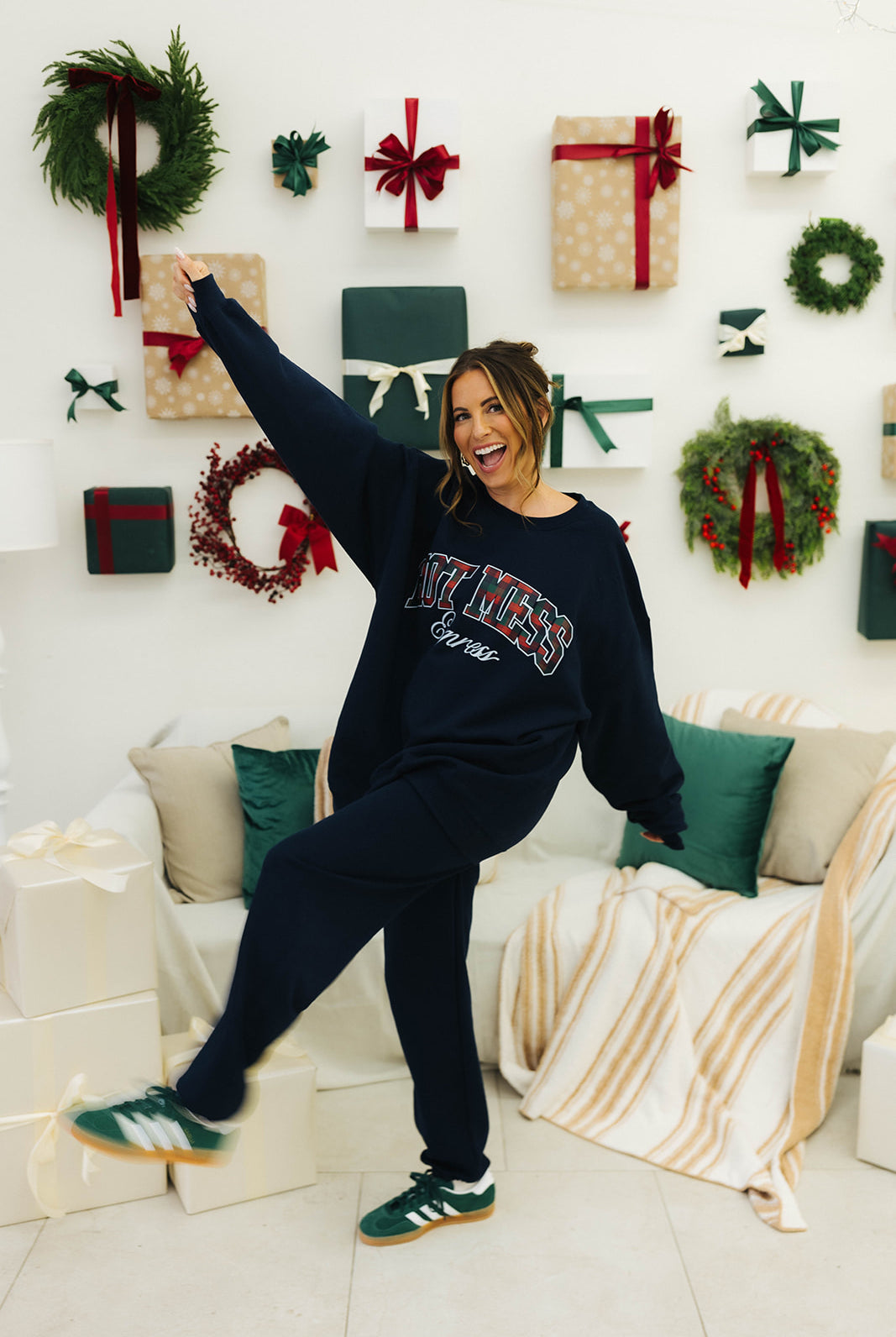 Person in a festive living room with Christmas decorations and presents.