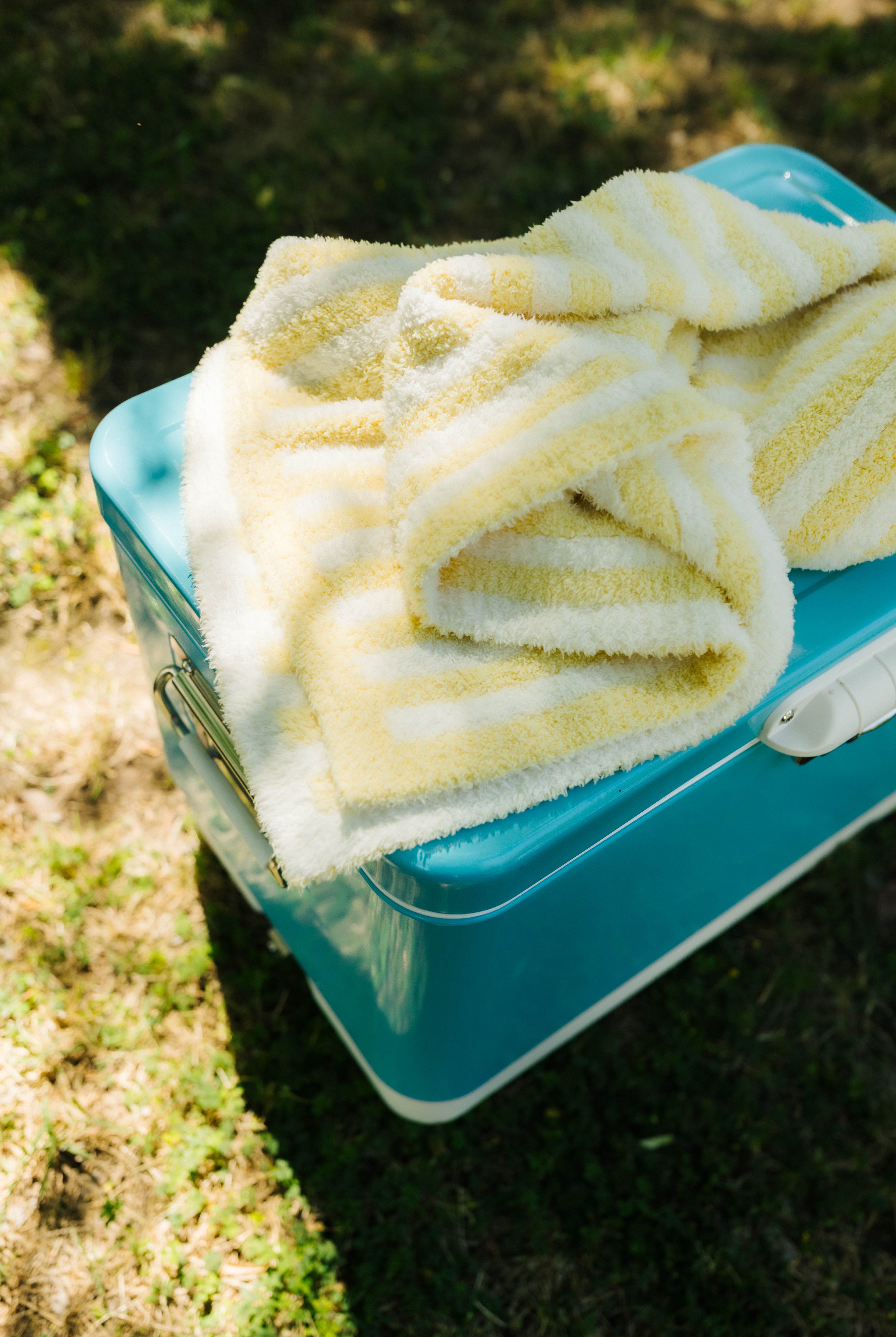 folded baby blanket on blue cooler