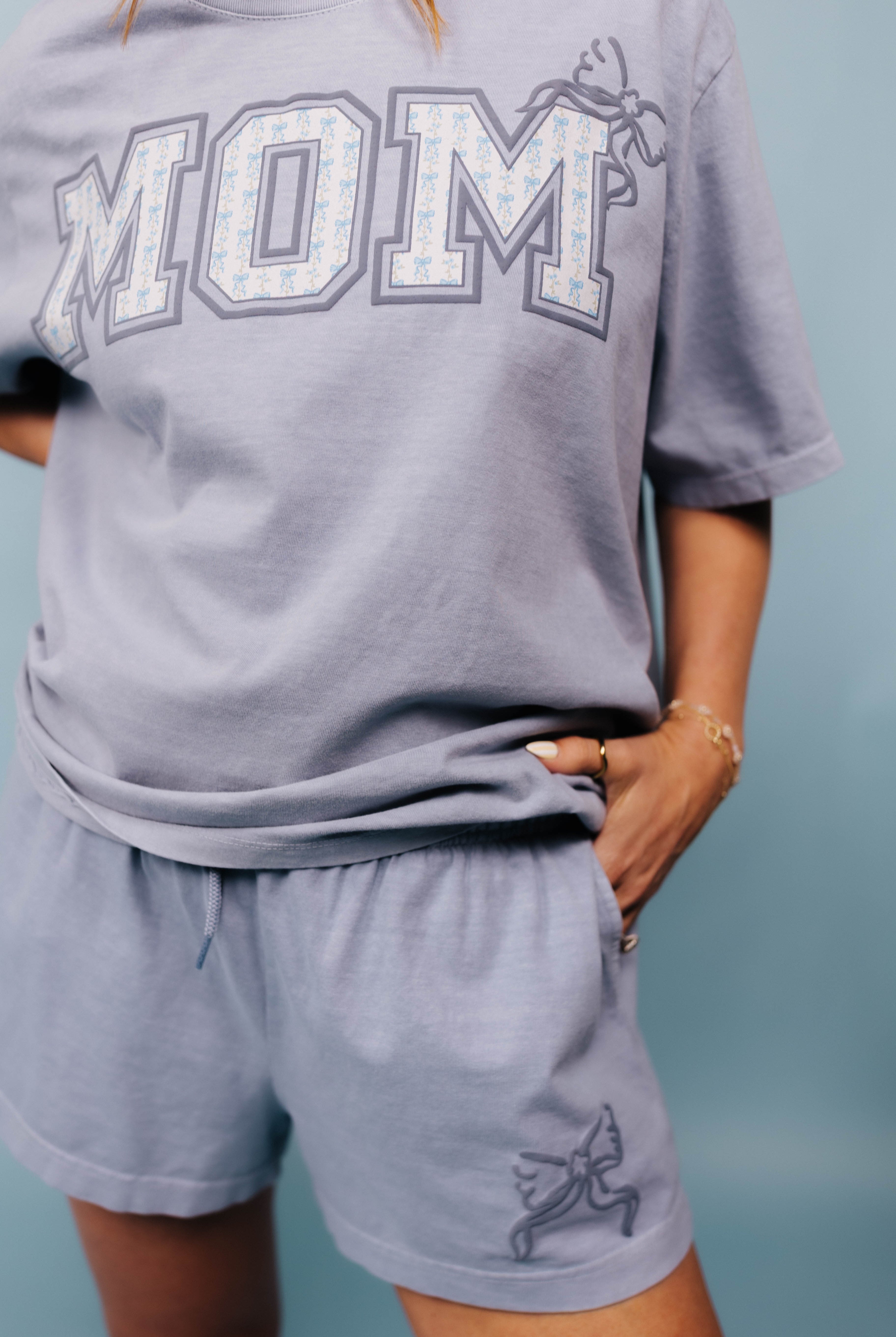 showing the blue mom shirt and bow shorts