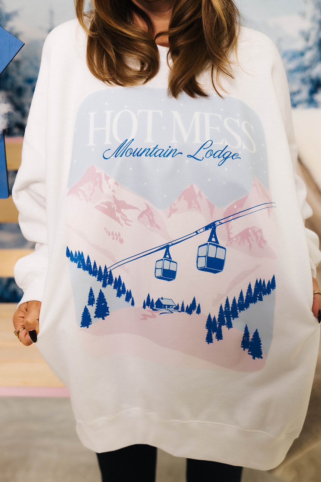 close up of graphic ski sweatshirt with pastel mountain scene