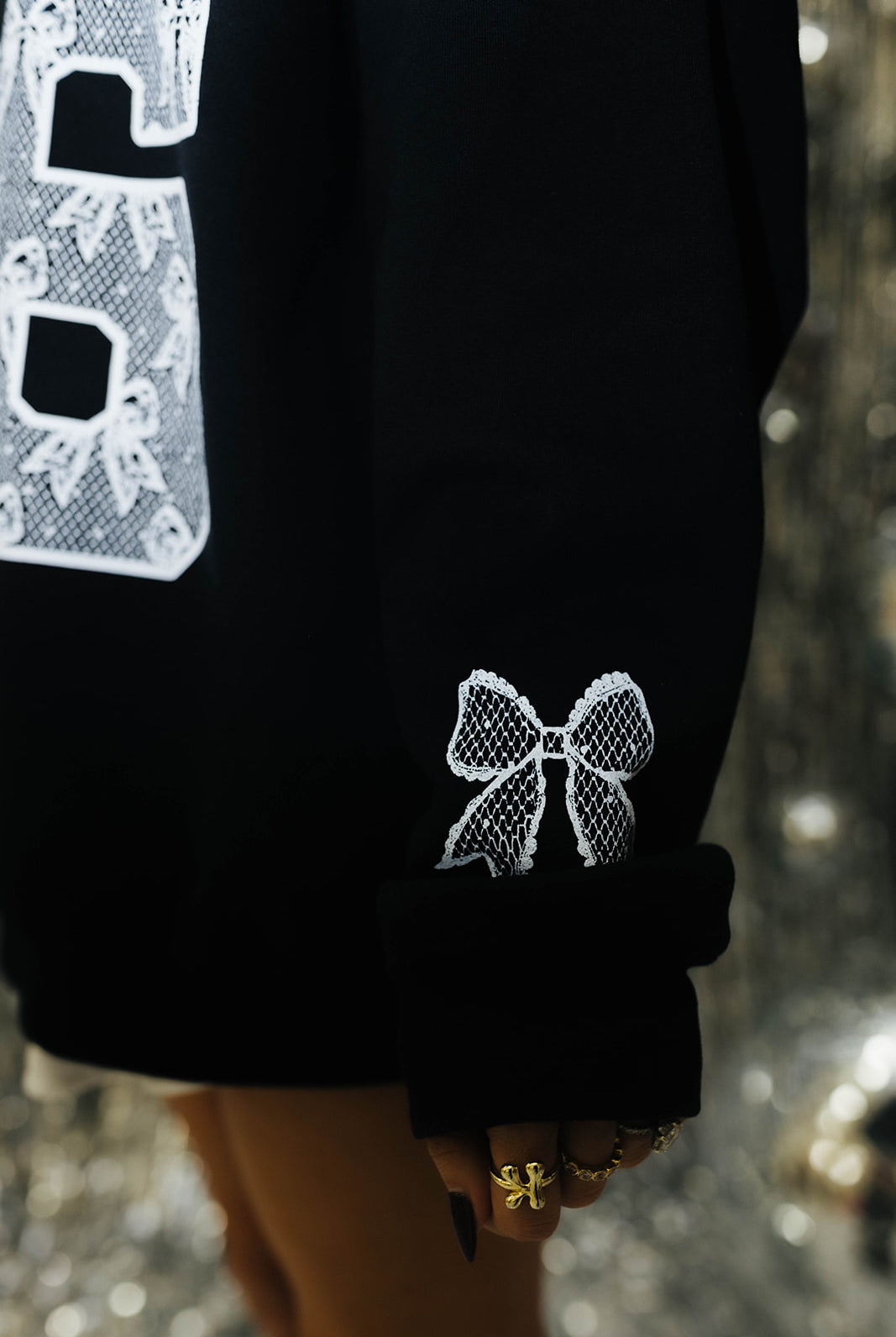 Close up of lace bow detailing on sleeve