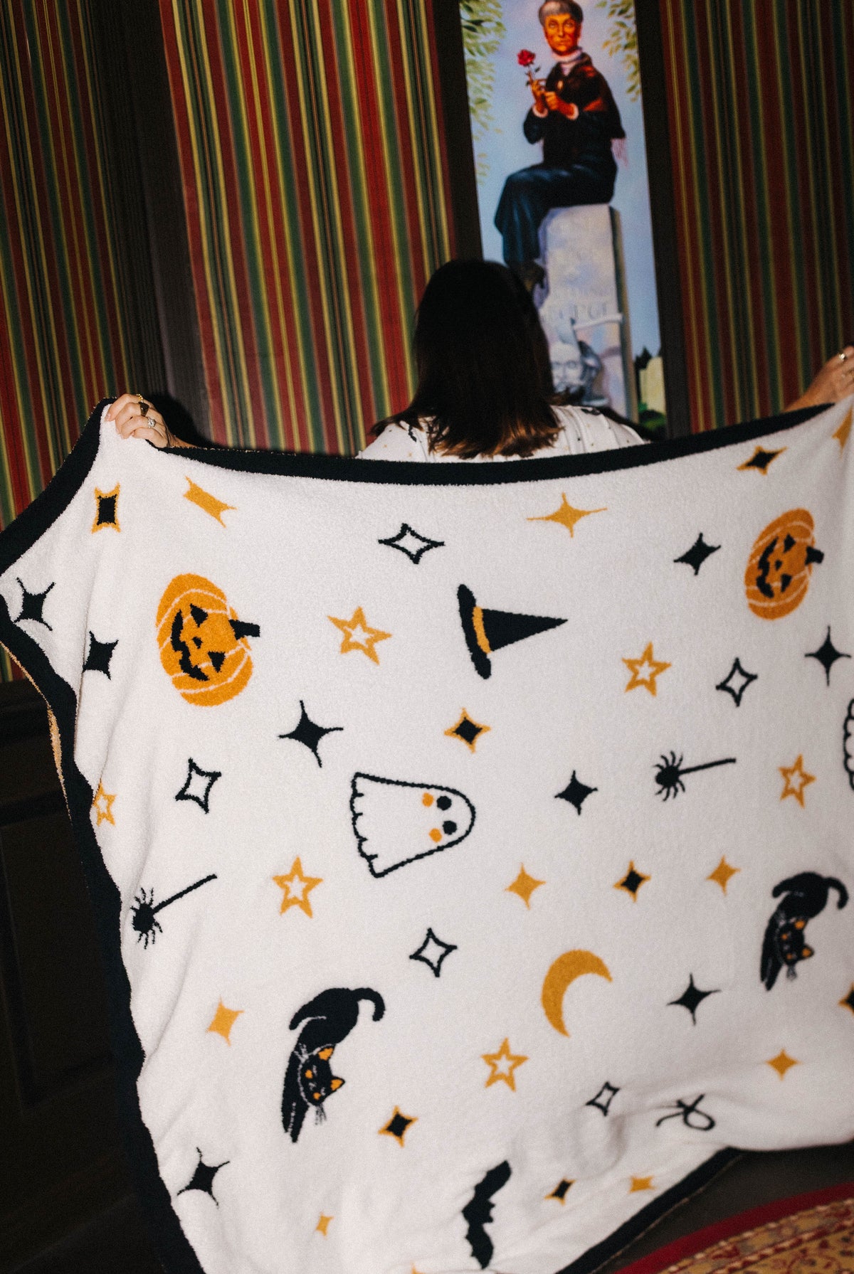 Halloween Icon Print blanket held open by a model