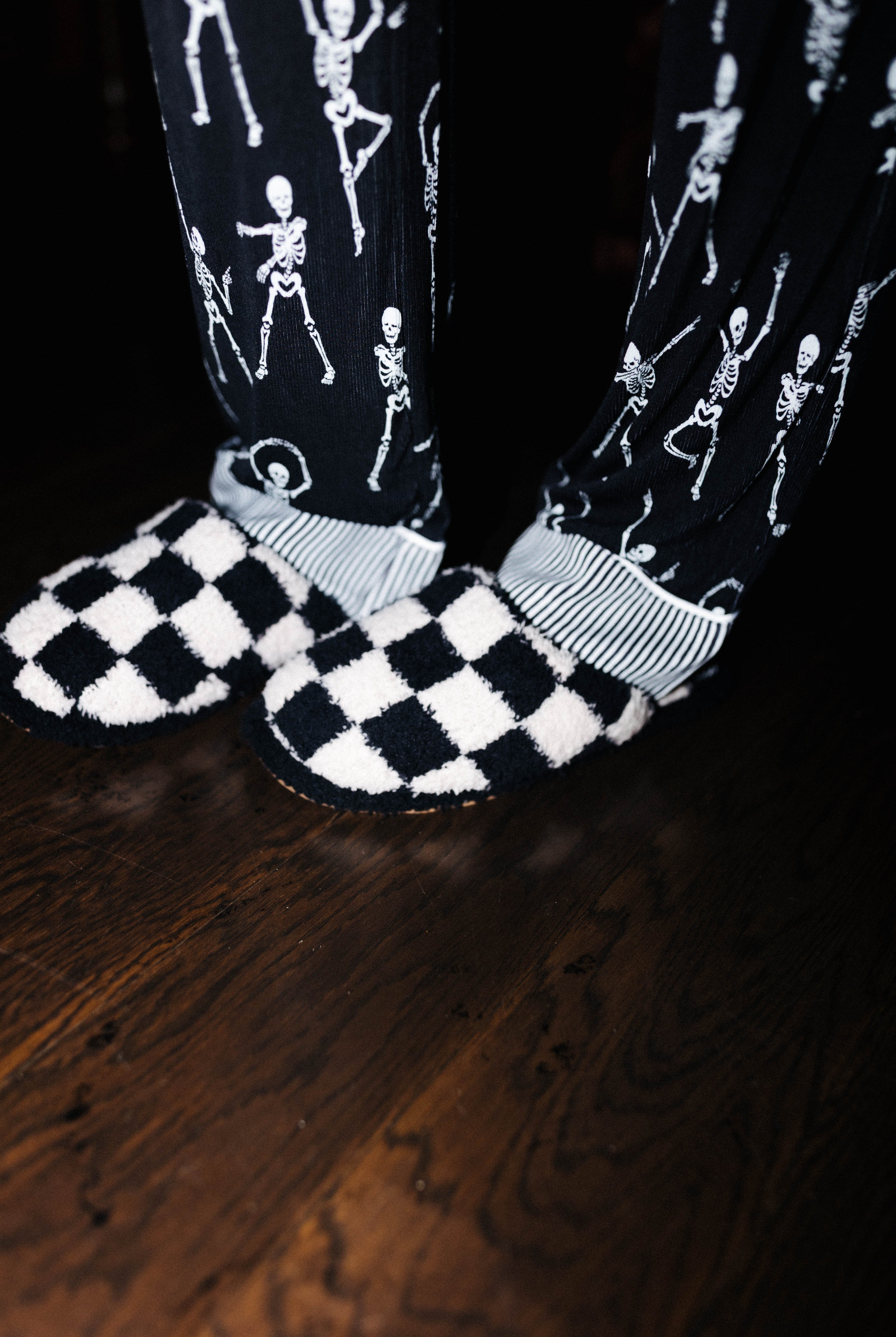 Sand and black check slippers worn with Skelly pajamas