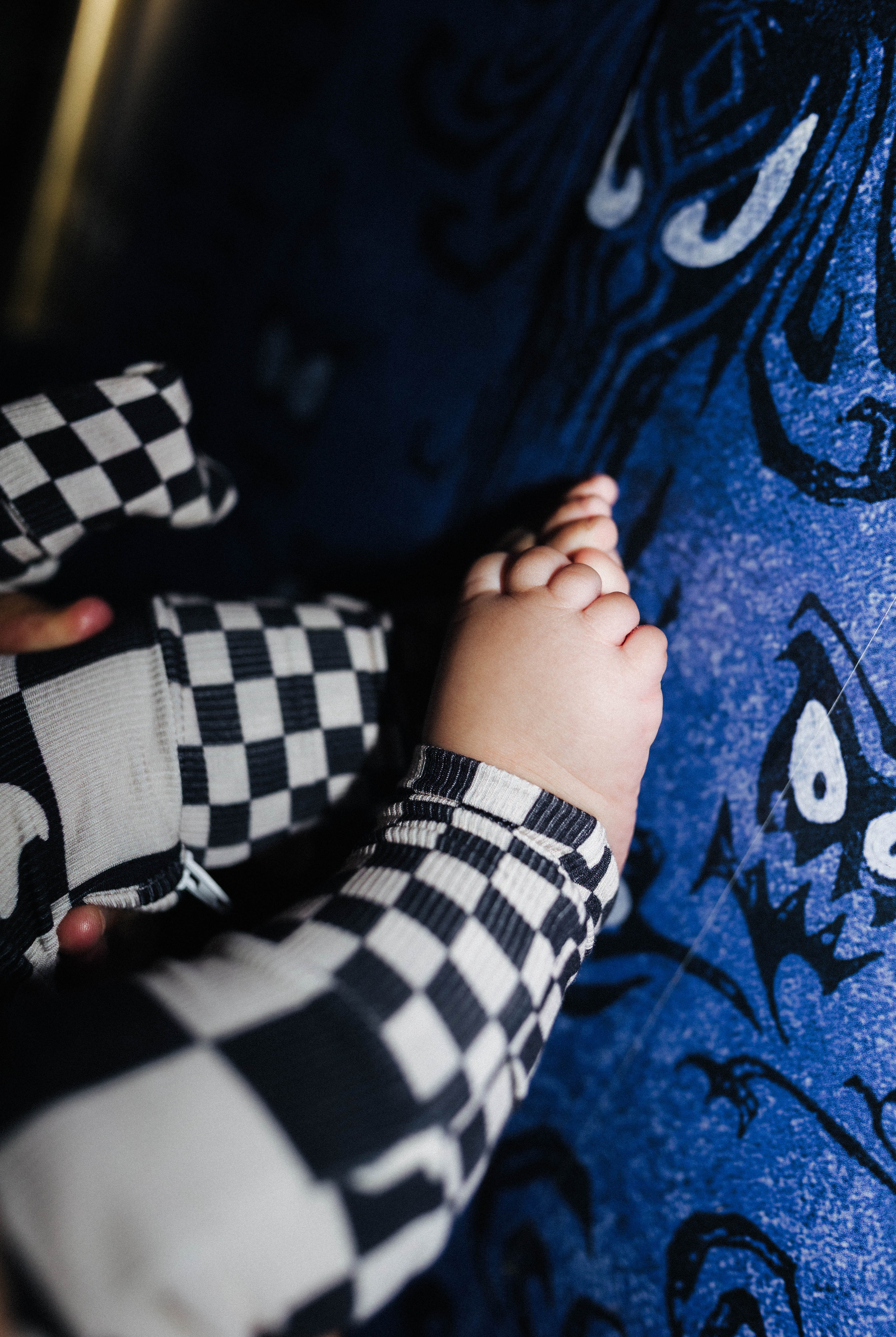 A close-up lifestyle shot of a baby's feet in the pjs