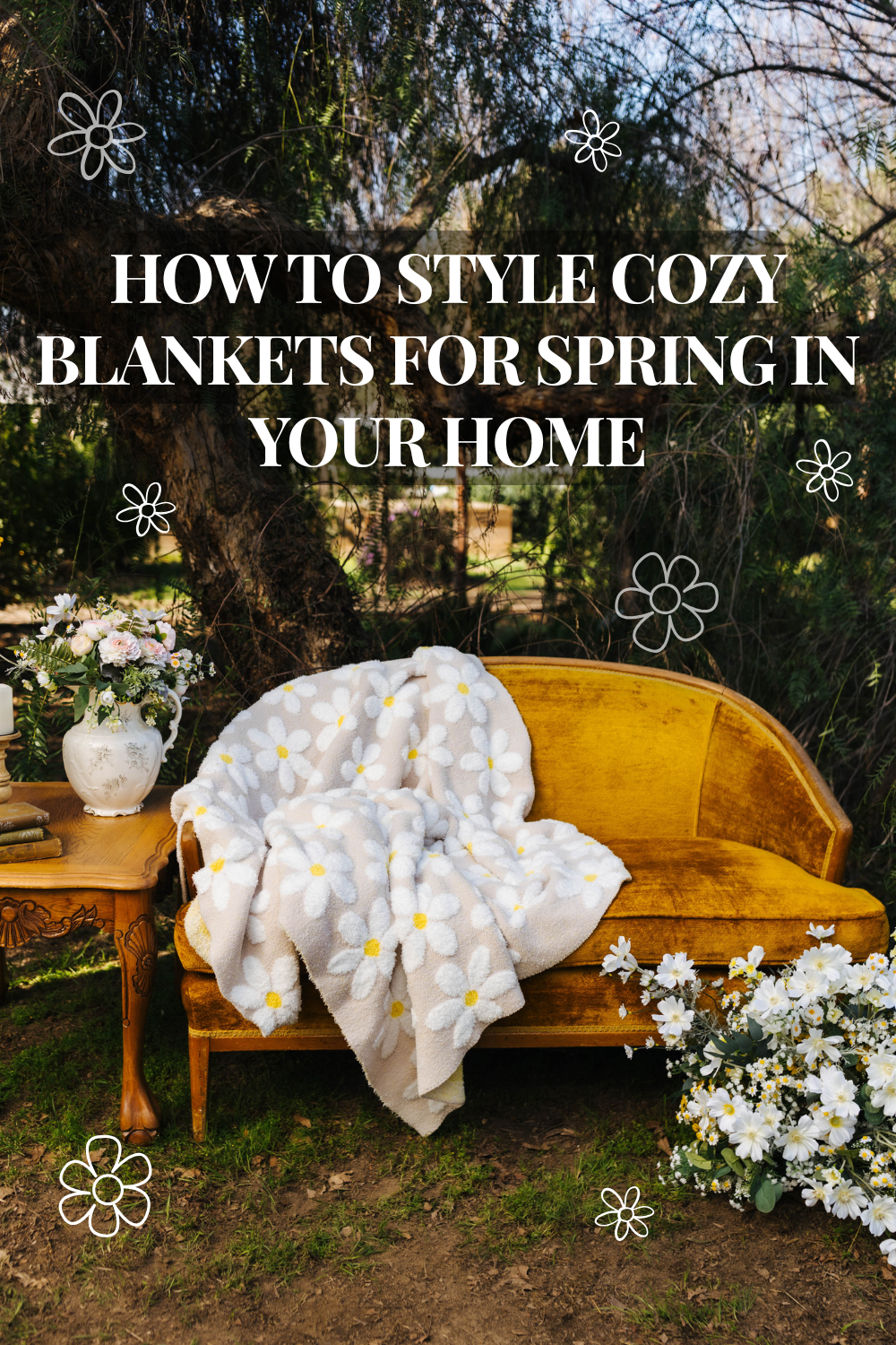 Spring outdoor setup with a vintage mustard velvet sofa styled with a soft daisy-patterned blanket, surrounded by fresh flowers and greenery, with text overlay reading “How to Style Cozy Blankets for Spring in Your Home