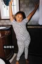 Ila wearing size 10/12 in the Kid Leopard Pajama Set
