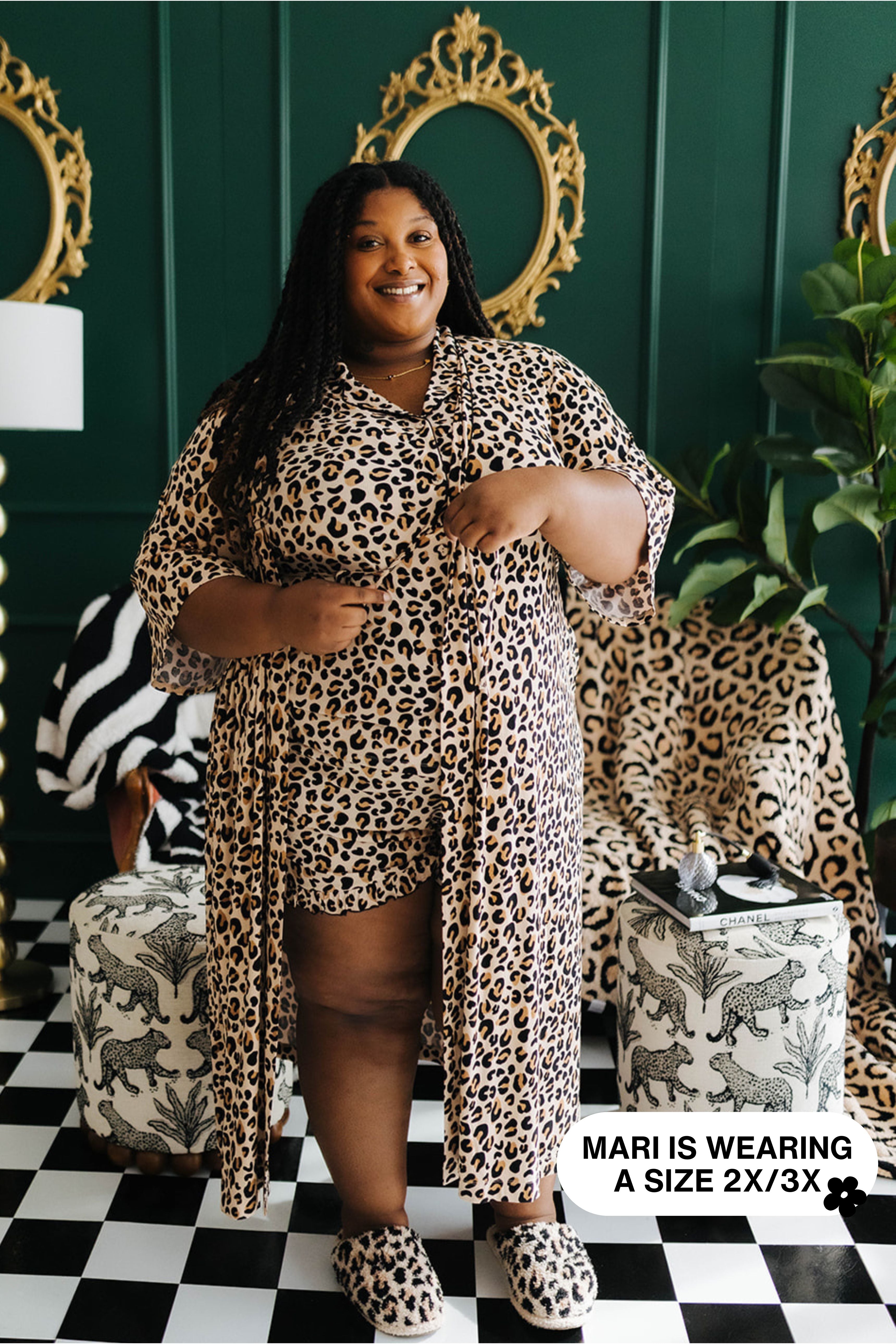 Woman wearing a leopard print outfit in a stylish room with decorative elements.