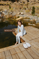 Sizing photo: Kolly in 7/8 wearing blue with brown polka dots kids pajama set.