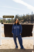 Sizing photo: Krista in M/L wearing blue Homebody sweatshirt and sweatpants.