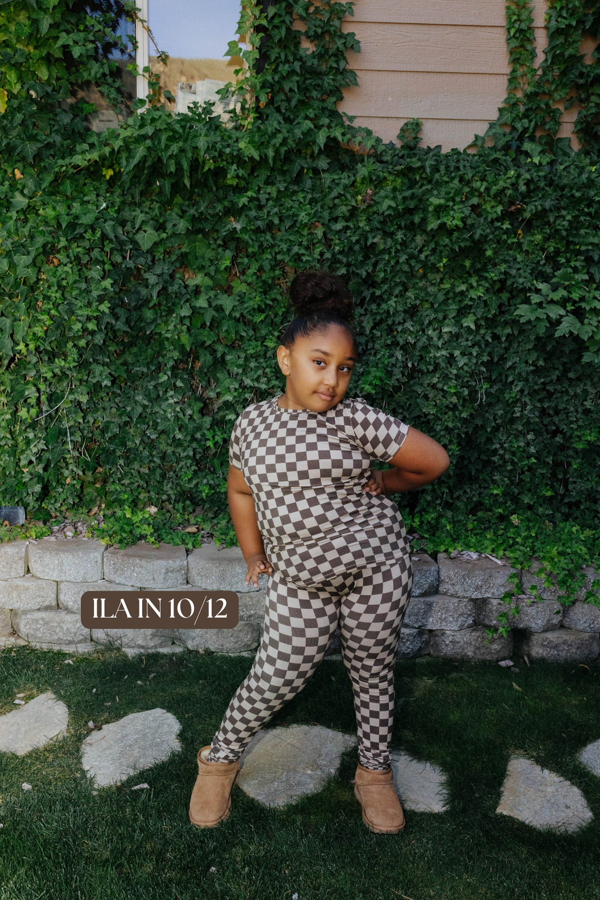 Sizing photo: Ilan in 10/12 wearing brown check kids pajama set.
