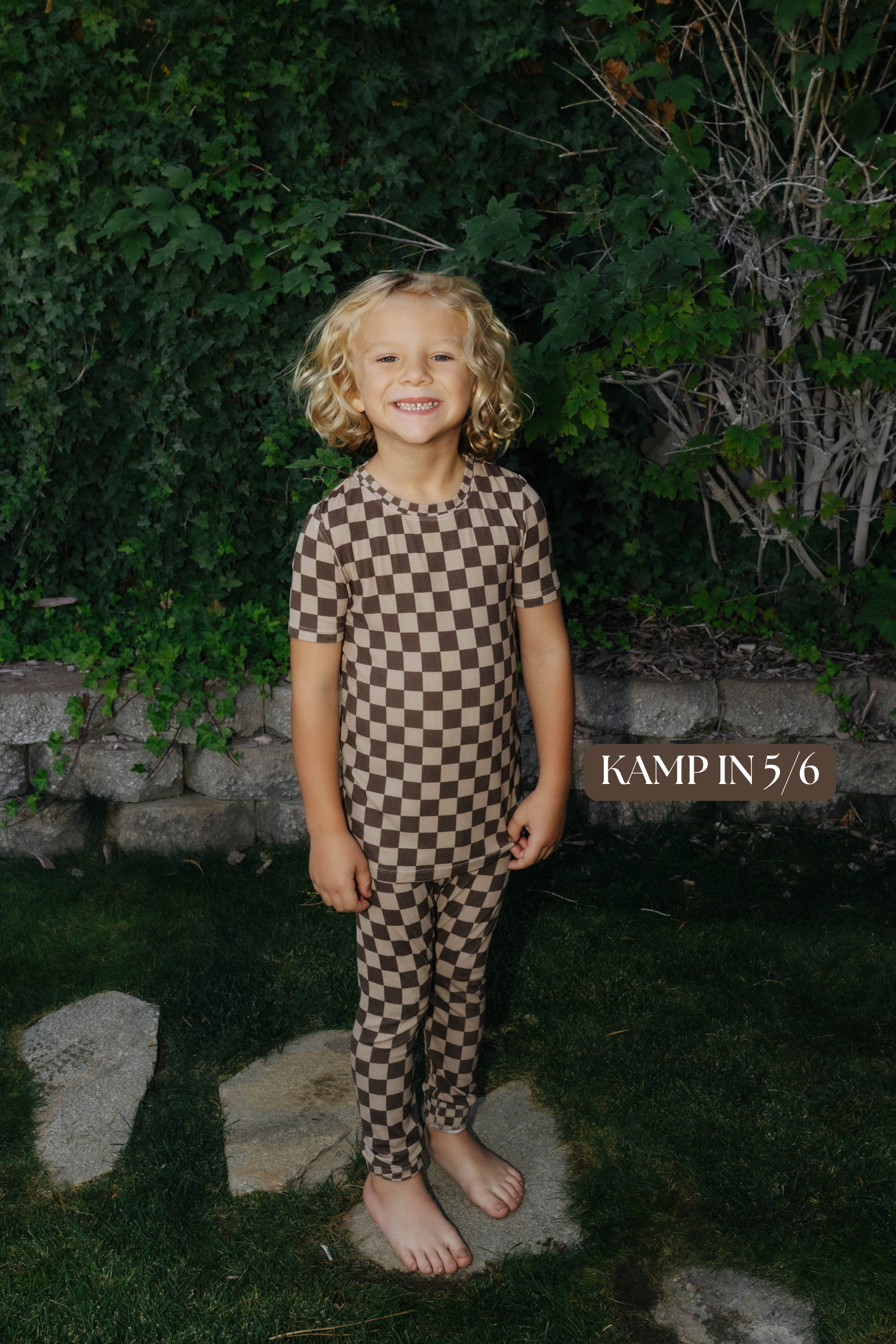 Sizing photo: Kampin in 5/6 wearing brown check kids pajama set.