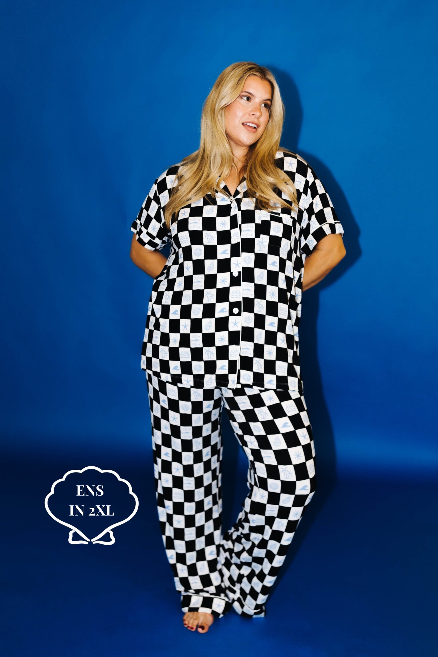Person wearing a black and white checkered outfit against a blue background