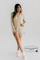 model smiling wearing size medium in lace polka dot pajamas