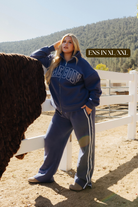 Sizing photo: Ens in XL/XXL wearing blue Homebody sweatshirt and sweatpants.