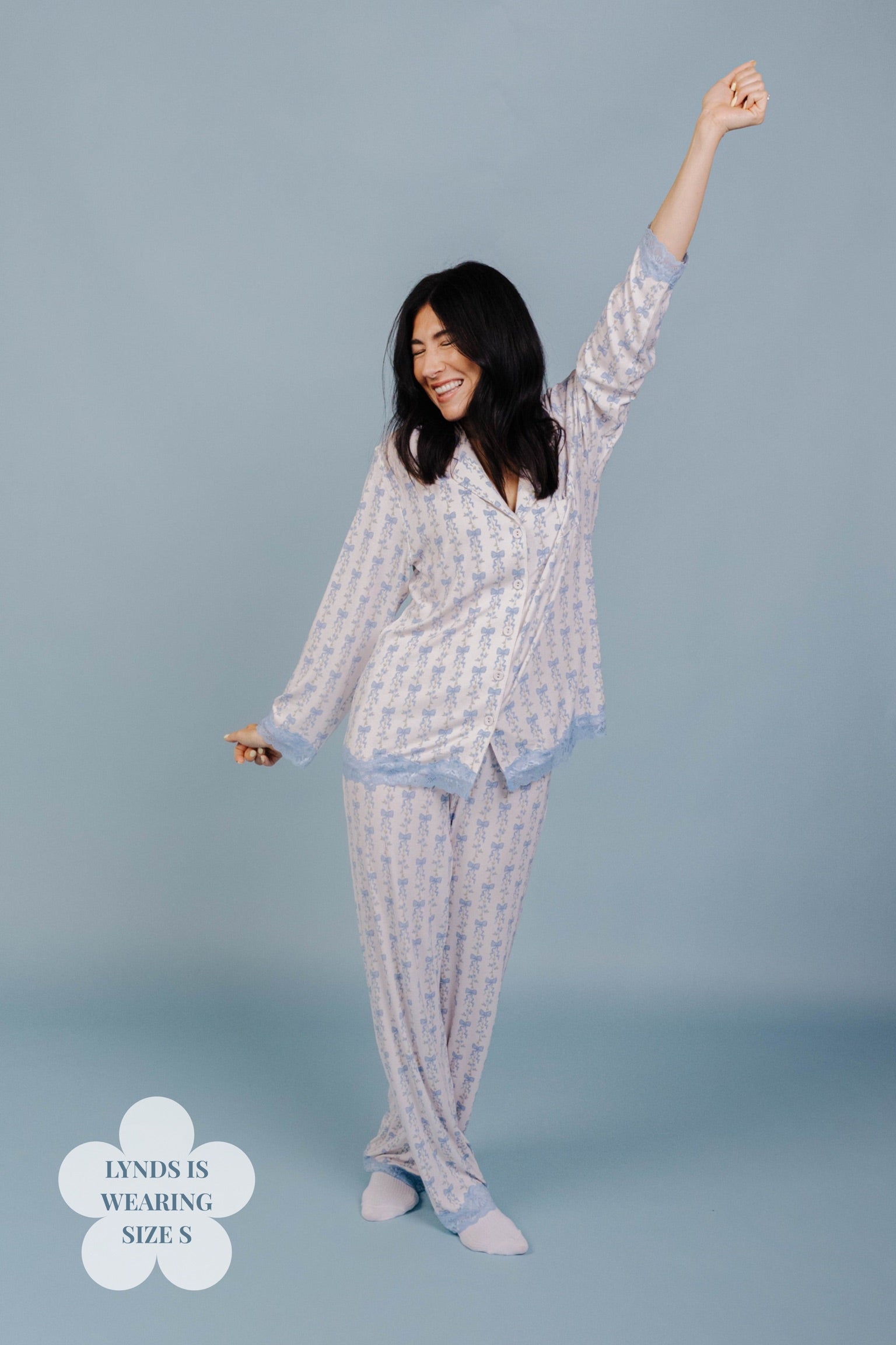 Woman wearing a size S pj on a blue background