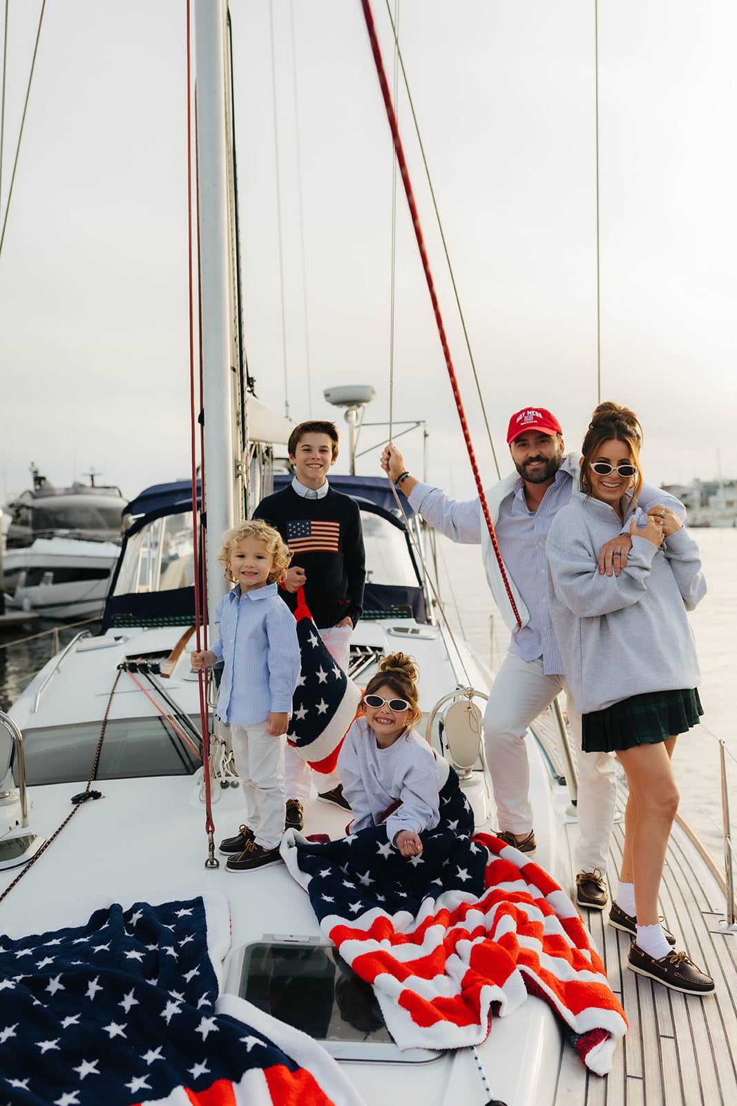 family styled with the blankets on a boat