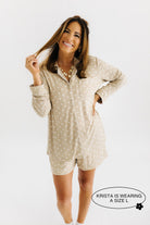 model krista smiling and twisting hair wearing size large in the lace polka dot pajamas