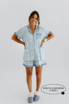model krista smiling with hands on hips wearing a size large in the cloud ruffle pajamas 