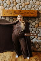 Sizing photo: Ens in XL/XXL wearing brown sweatshirt with blue bow and matching sweatpants.