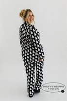 model ensley smiling looking back showing the ghost pajamas in size 2xl