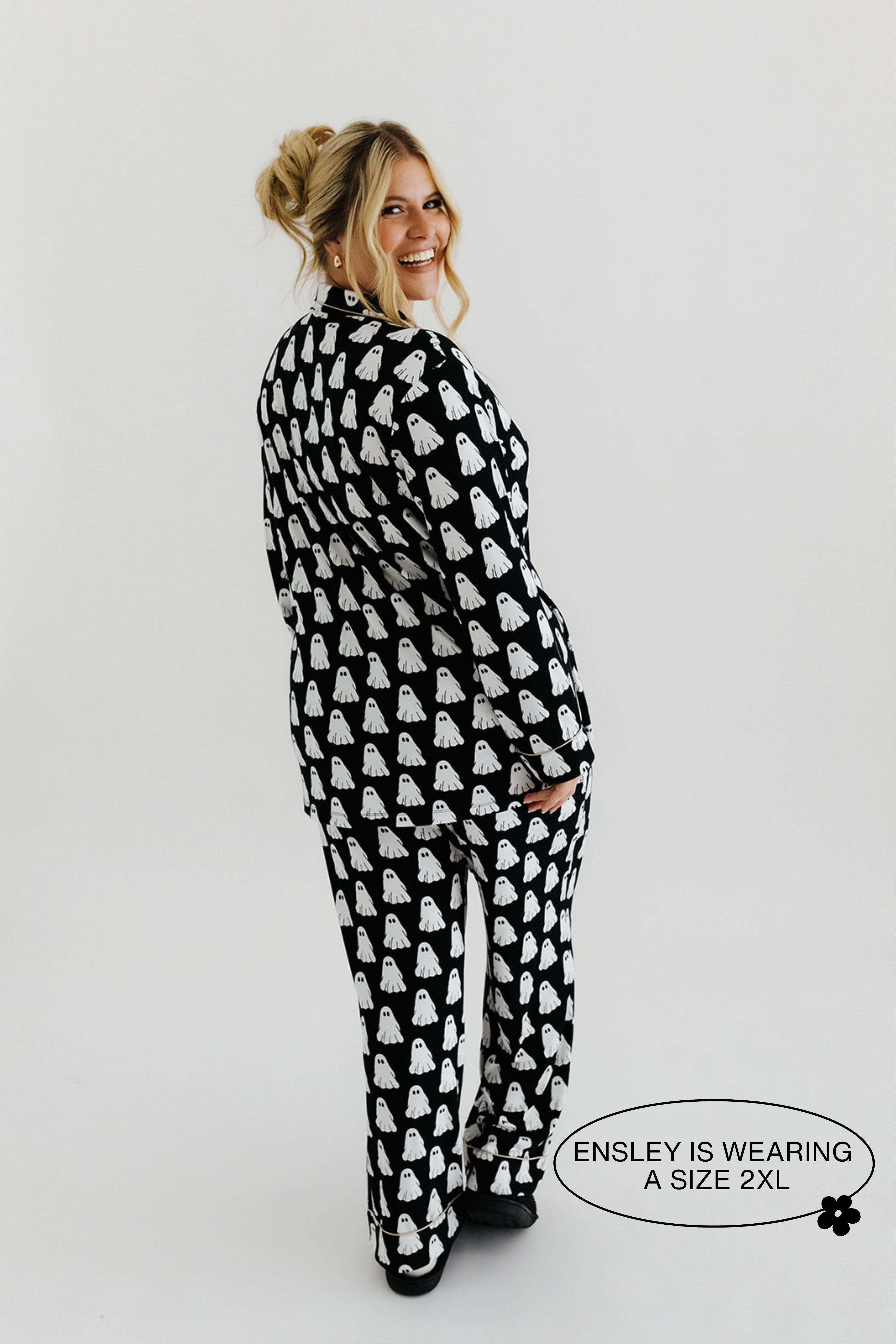 model ensley smiling looking back showing the ghost pajamas in size 2xl