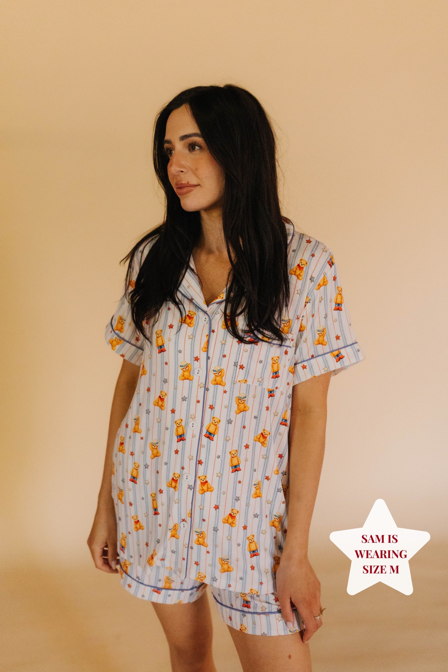 Size M model posing in front of cream background
