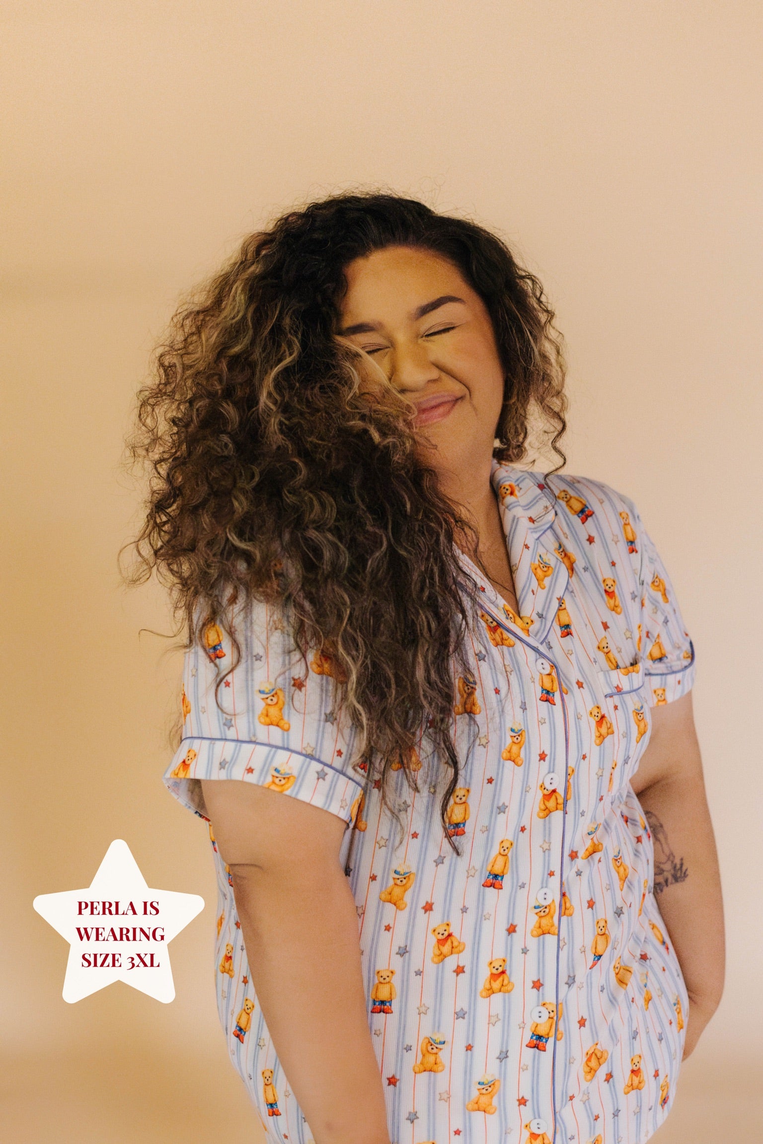 Size 3XL model posing in front of cream background