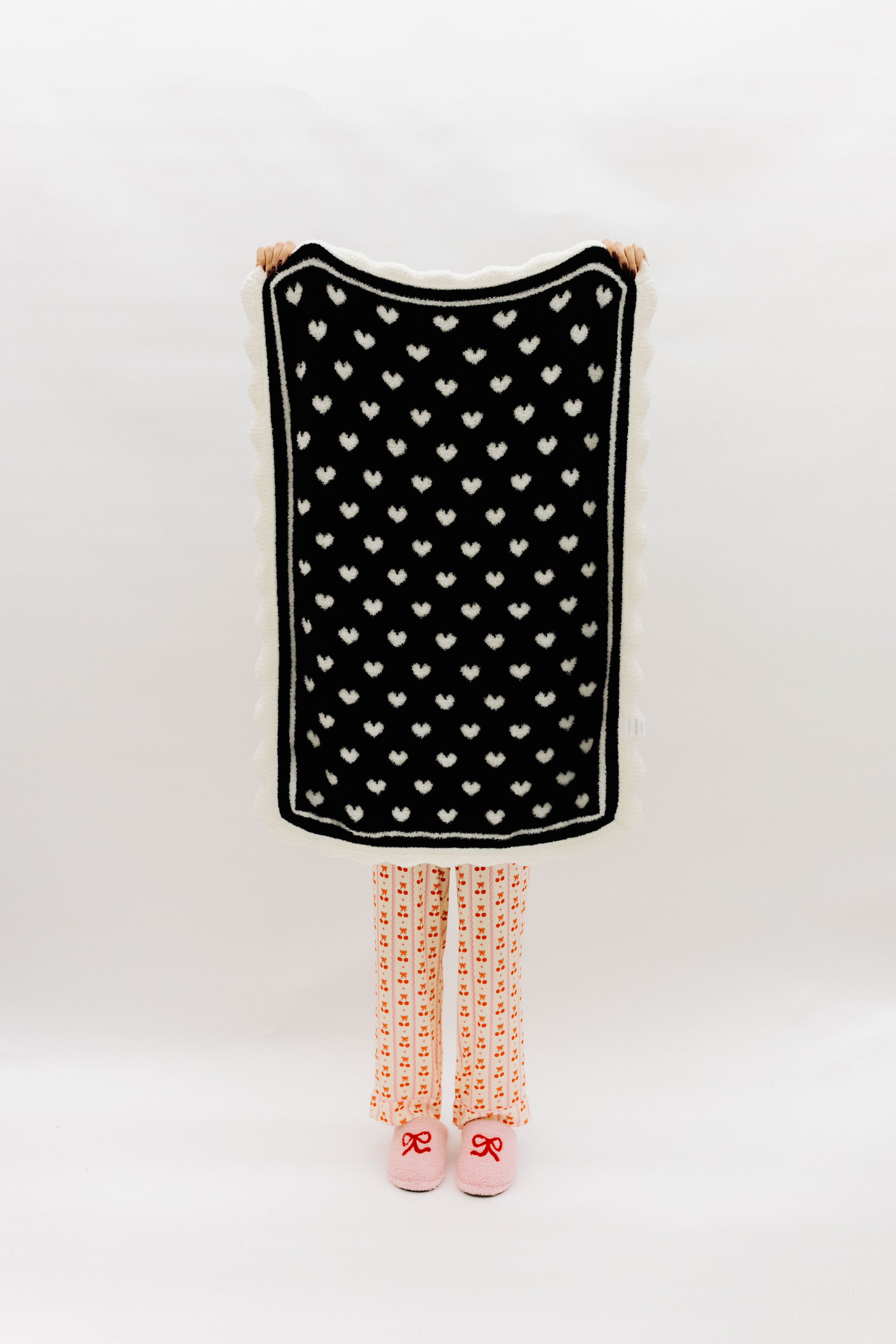 Black side of blanket with white hearts