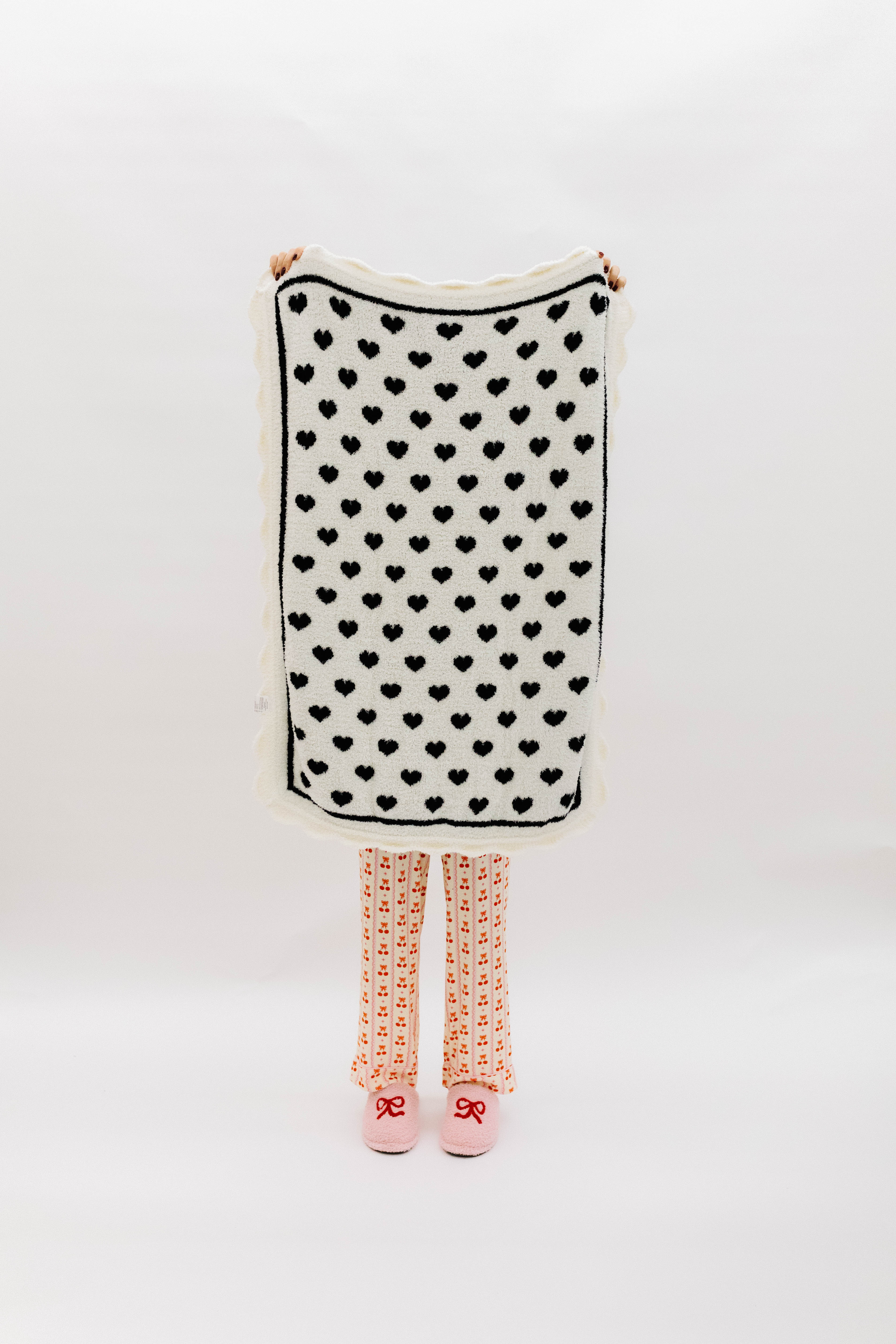 White side of blanket with black hearts