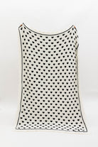 Other side of blanket showing a white base and black hearts