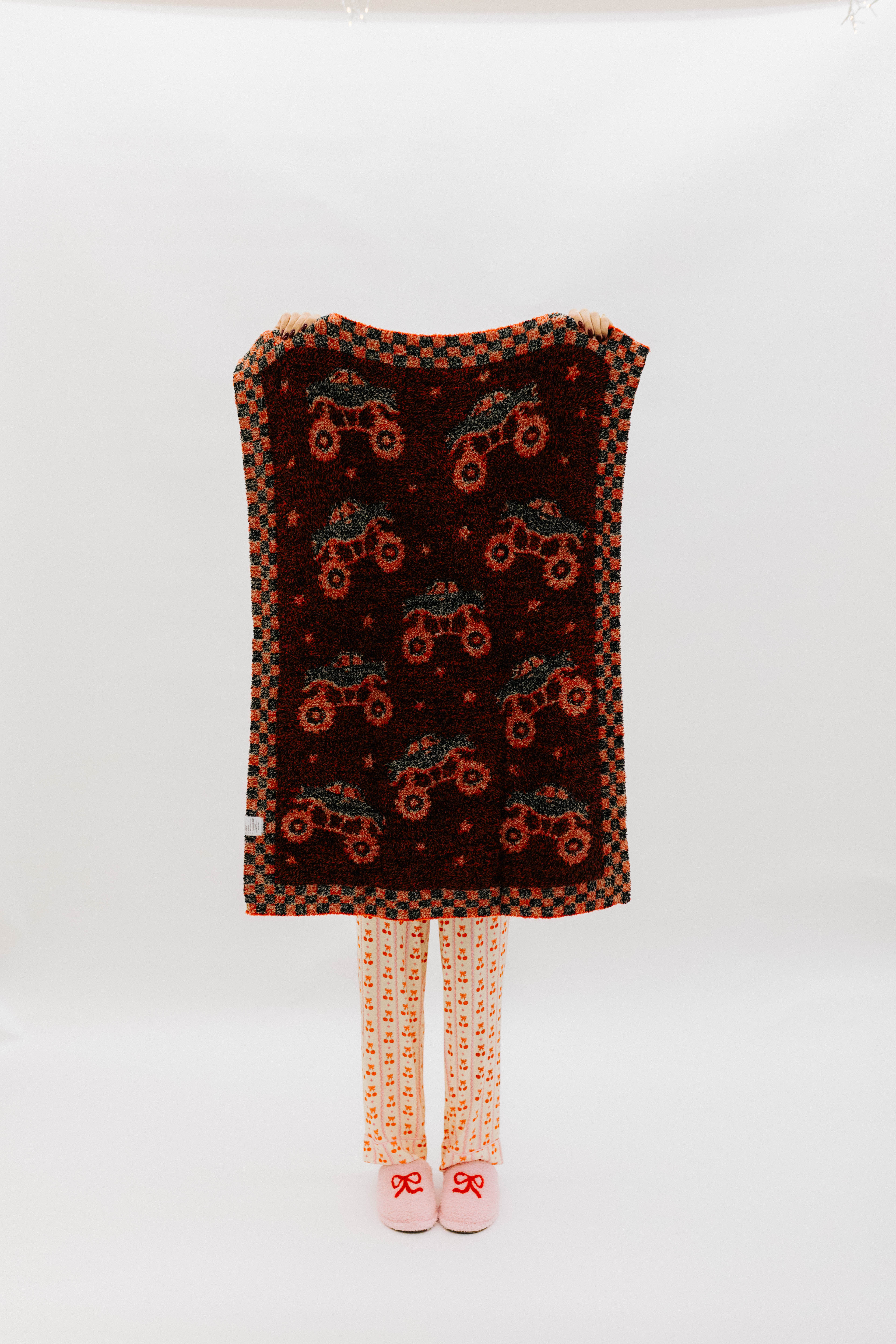 Back of the blanket showing mostly red and black mixed background.