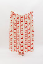 Holding the cherry bow quillow so it shows the full size (front side)