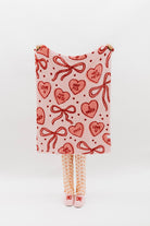 Blanket with red heart and bow pattern on a white background