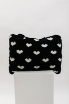 black and white heart quillow on a pedestal