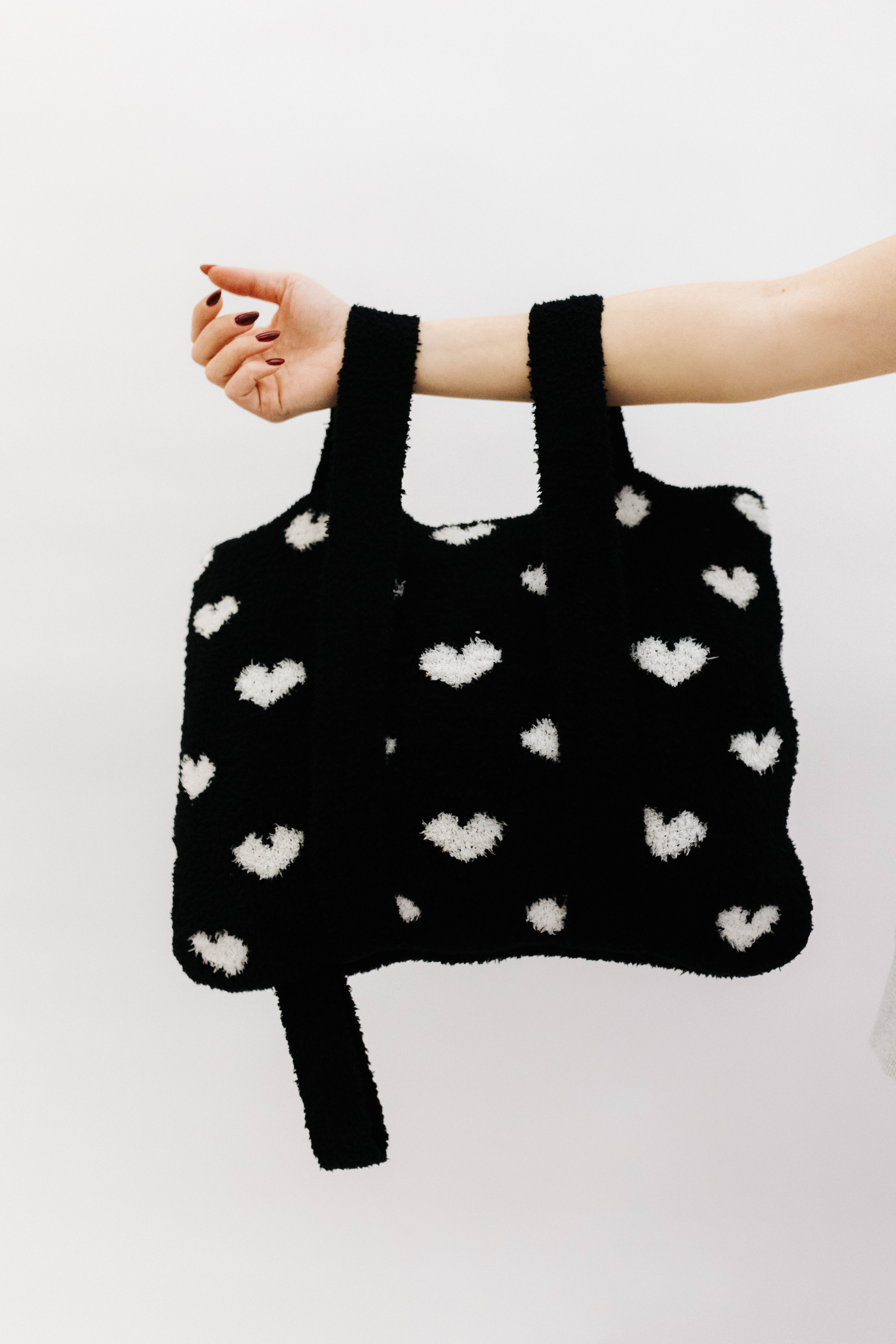 holding the back and  white quillow by the backpack straps
