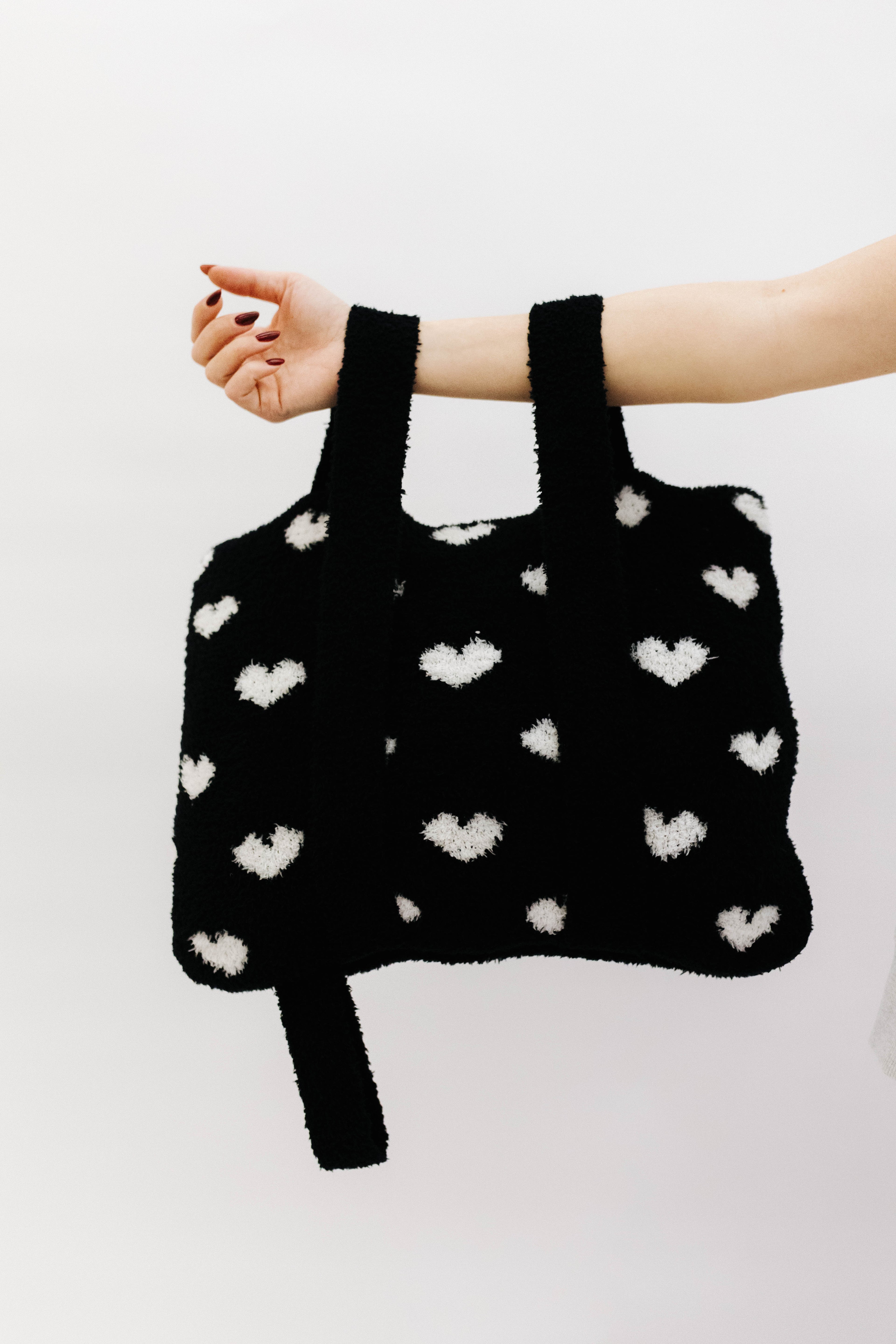 holding the back and  white quillow by the backpack straps
