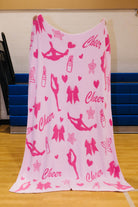 front of cheer blanket showing light pink background and stars, lipstick, hearts, bows, and figures doing stretches/jumps
