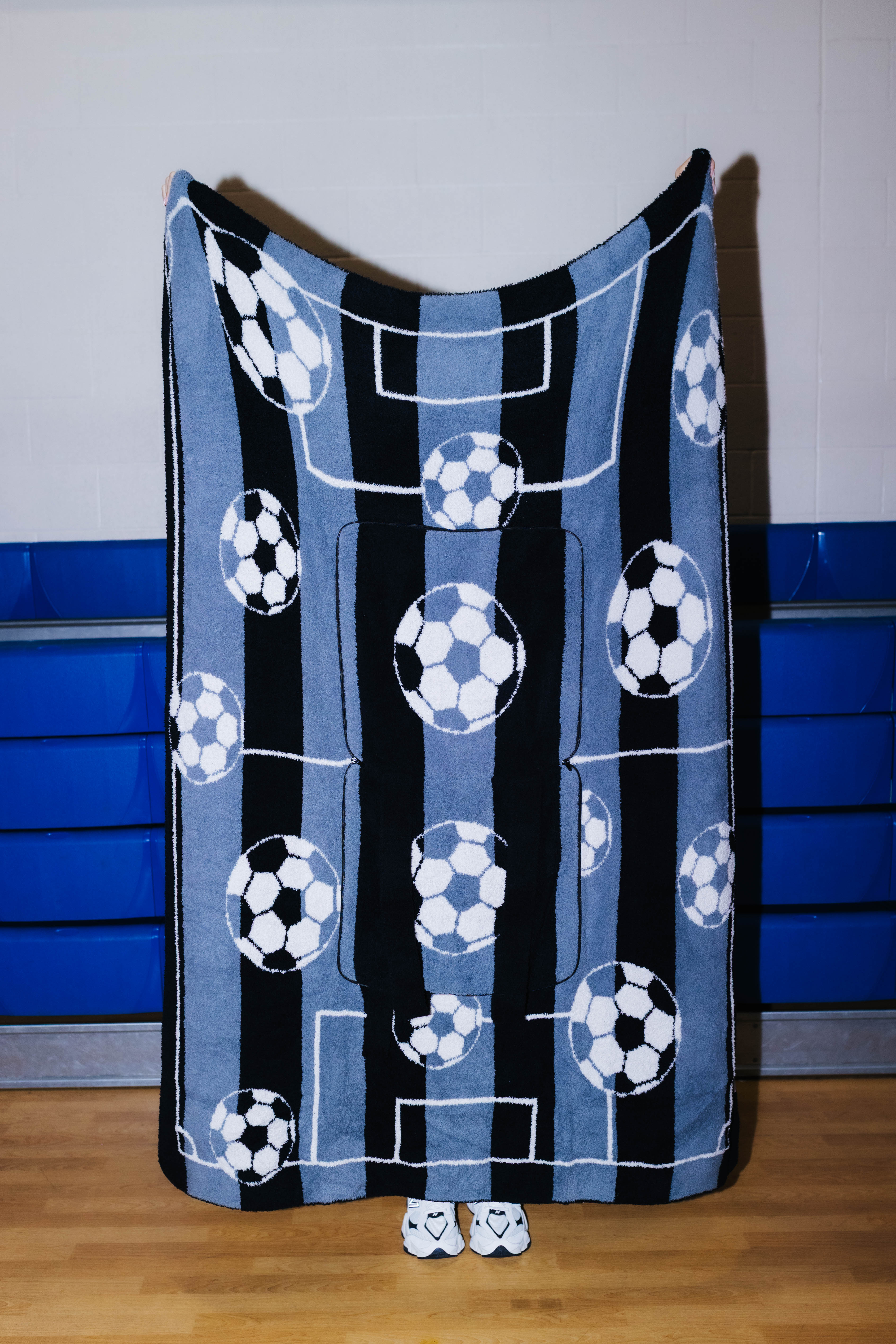 quillow held up showing the soccer balls and black/white lines looking like a field