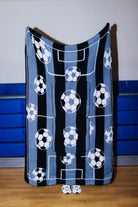quillow held up showing the soccer balls and black/white lines looking like a field