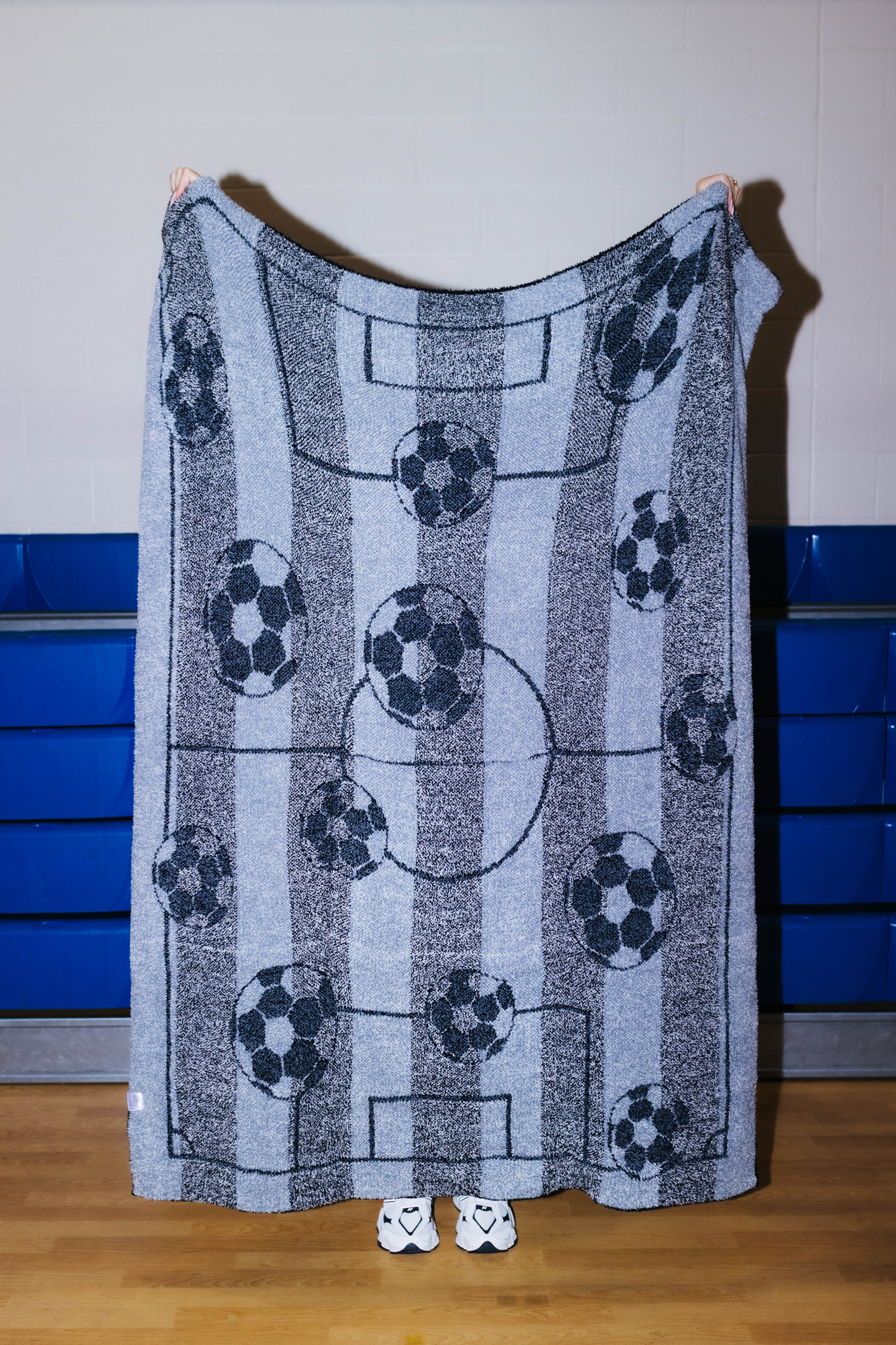 Back of the blanket showing the outline of the soccer balls and fields - mostly black and gray