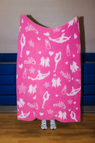 dark pink side of the cheer quillow showing light pink icons such as girls in stretches, lipstick, stars, hearts, cheer, and bows 