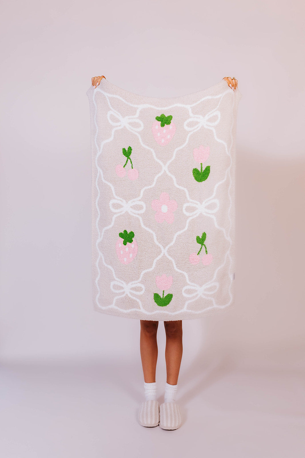 holding up the bow grid blanket to see the front of the design
